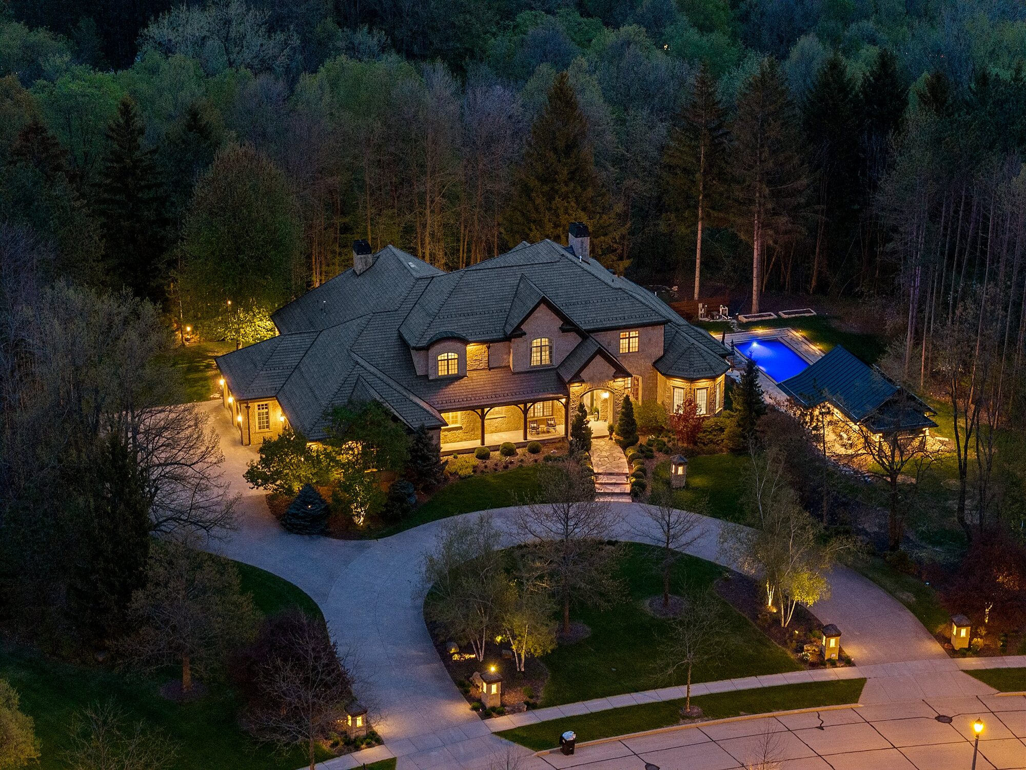 Aerial view at dusk with pool and pool house
