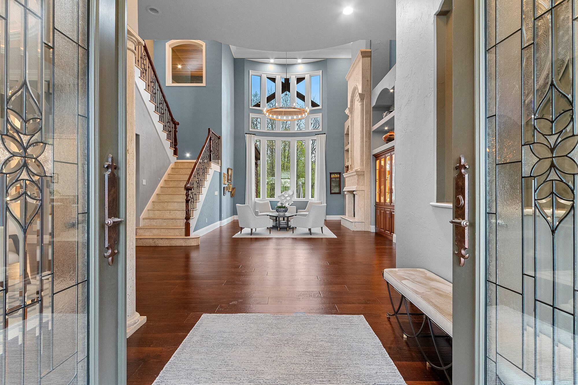 Grand foyer with two-story windows and art-glass doors