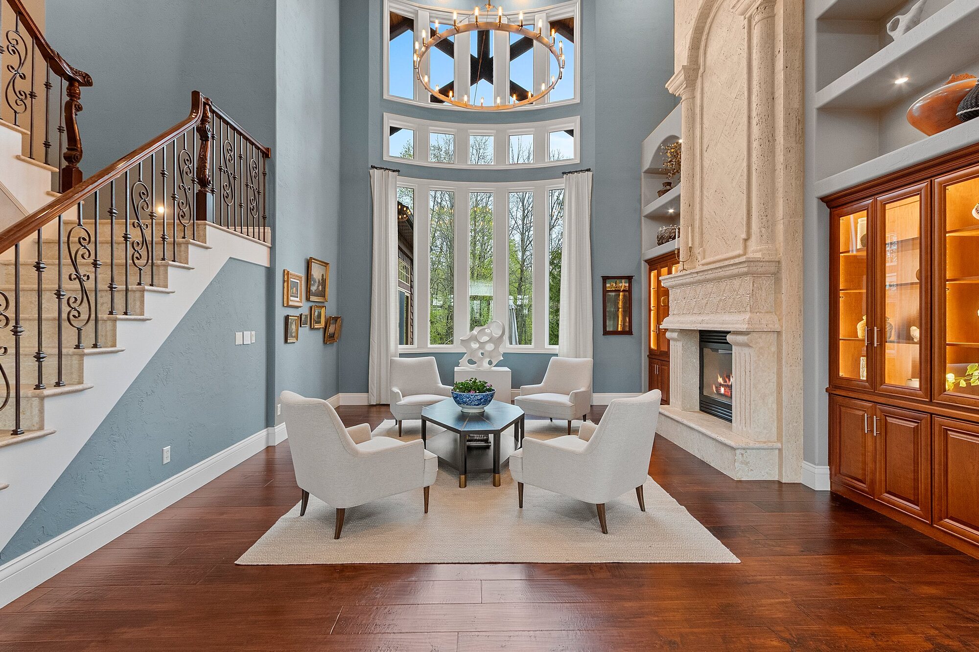 Great room with chandelier and two-story windows