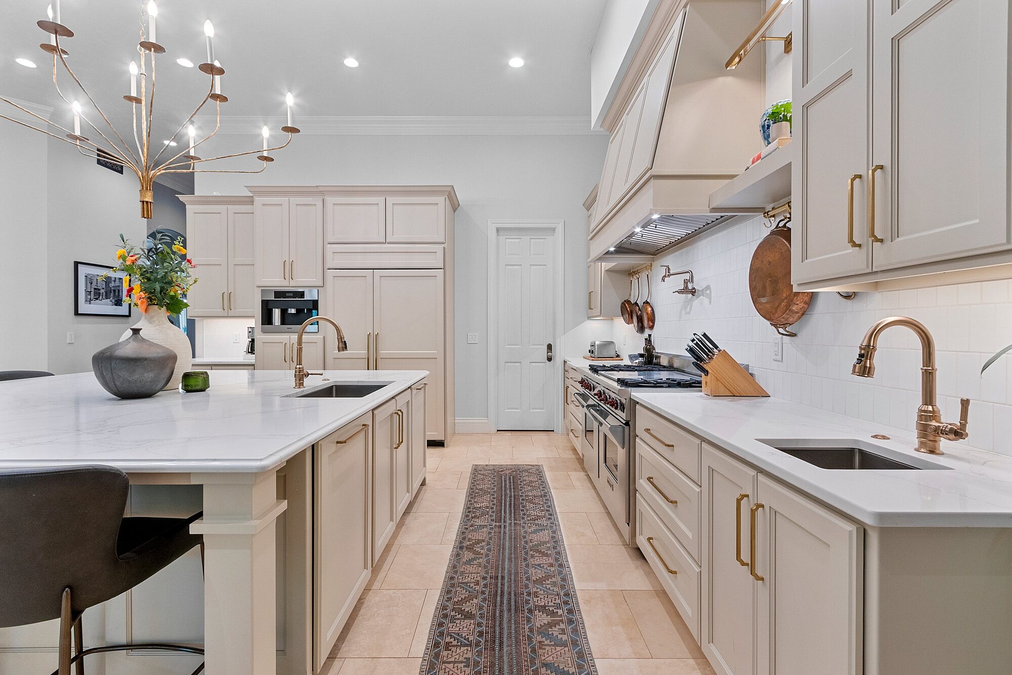 Kitchen with quartz island, Wolf range, and custom cabinetry