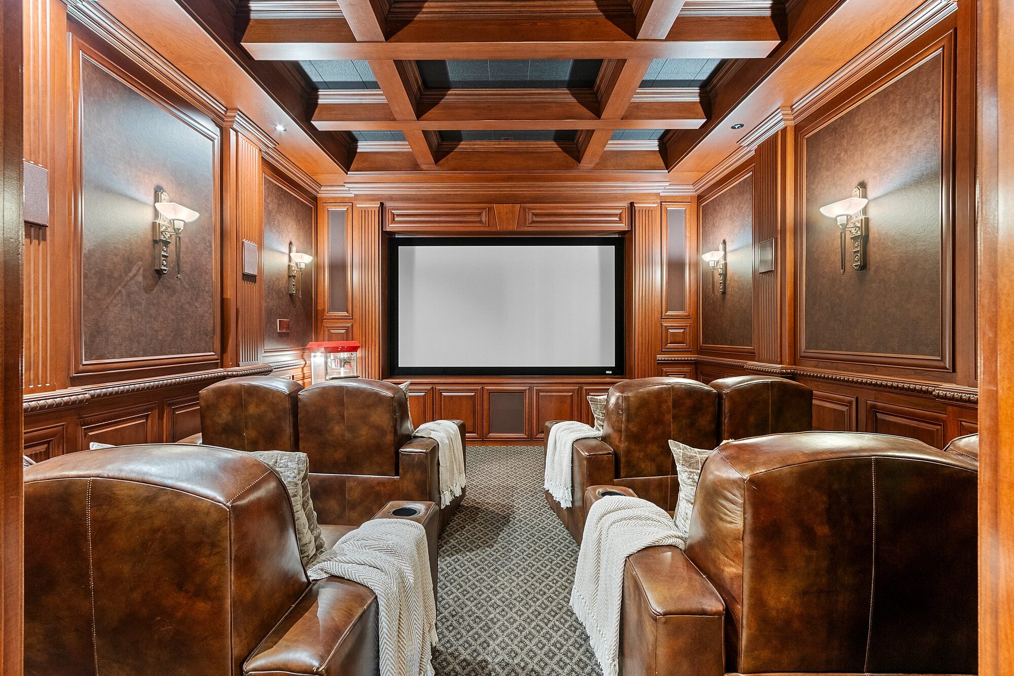 Coffered ceiling home theatre room with leather seating